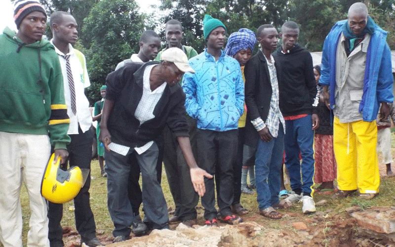 School children drops into school a pit latrine