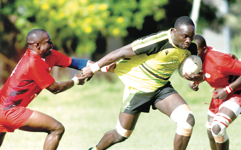 Kabras lock Brian Juma fends off Impala Saracens outside centre George Okowa to sprint to the try zone. PHOTO/Alex Njue