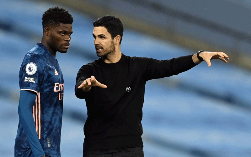 Arsenal’s midfielder Thomas Partey (left) receives instructions from Arsenal’s Spanish manager Mikel Arteta during their English Premier League match against Manchester City at the Etihad Stadium in Manchester. PHOTO/AFP