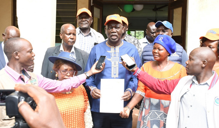 Teso North MP Oku Kaunya speaks to the press at Amagoro IEBC offices after receiving his clearance certificate. PHOTO/KNA