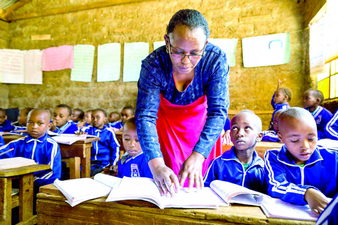 A teacher and her students in class. In its manifesto, Kenya Kwanza Alliance commits to equitable universal education — defined as 12 years of schooling. PD/FILE