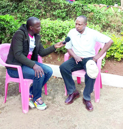 Sports Journalist Vincent Voiyoh (left) interviews Charles Kimathi in Nyeri last week. PD/ DAVID NDOLO