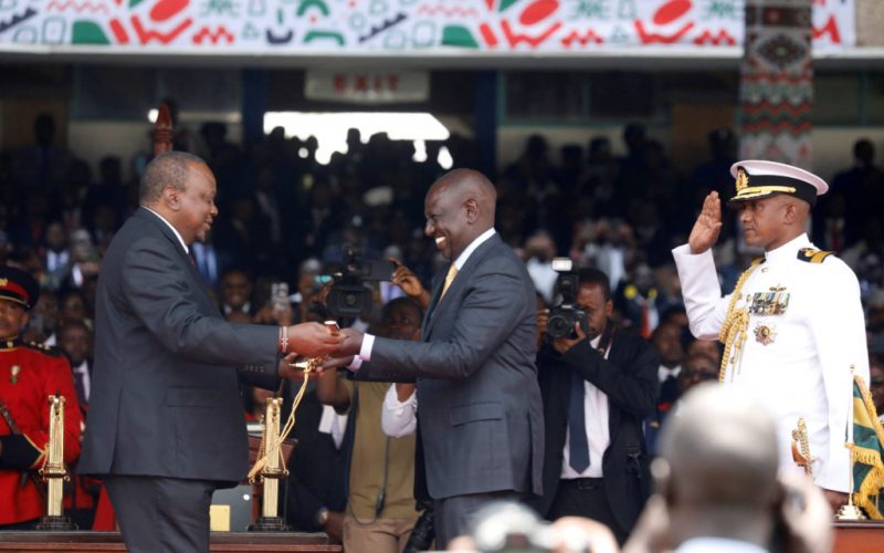 Kenya's President William Ruto receives a sword to represent his instruments of power and authority from his predecessor Uhuru Kenyatta after his official swearing-in ceremony at Moi International Stadiumi n Nairobi, Kenya September 13, 2022.