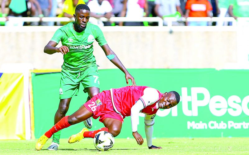 PG 31-David Owino of Kenya Police FC (Below) clears the ball under pressure from Austine Odhiambo of Gor Mahia FC during their FKF-PL match held at Kasarani Stadium, Nairobi on February 25 2023.PHOTO/Rodgers Ndegwa