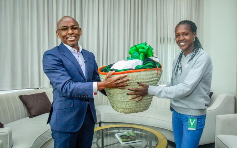 Faith Kipyegon with Safaricom CEO Peter Ndegwa. PHOTO/ @SafaricomPLC)/Safaricom/Twitter.