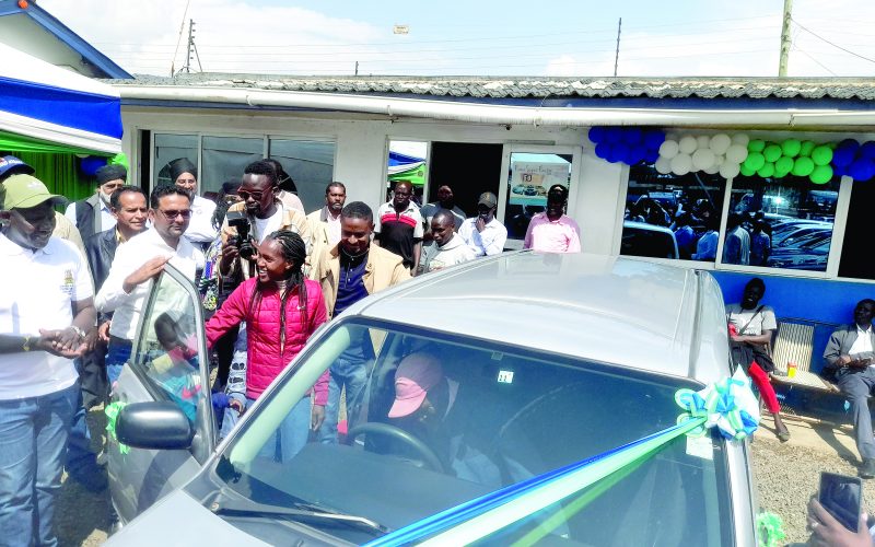 Double World Record holder Faith Kipyegon (left) with the car she bought her father as a gift at the weekend.