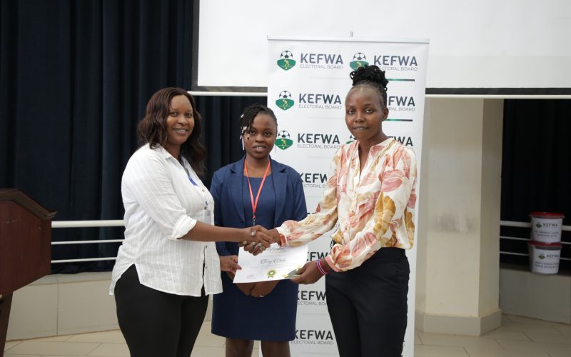 FKF Nairobi East Vice-chairman Hilda Nduta alongside KEFWA Elections Board Chairperson Marion Wambui award a certificate to incoming KEFWA Vice-President Terry Ouko following the elections held at Zetech University in Ruiru. PHOTO/Barry Silah