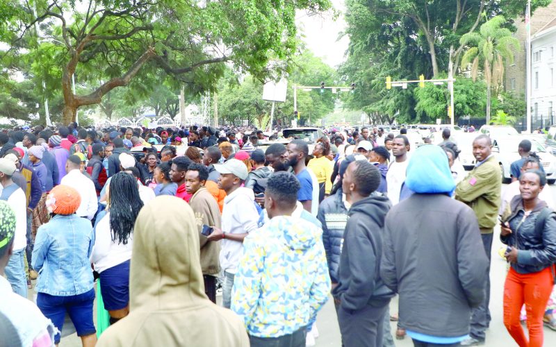 Youth queue to register as members of the new Worldcoin cryptocurrency at KICC Nairobi on Tuesday.