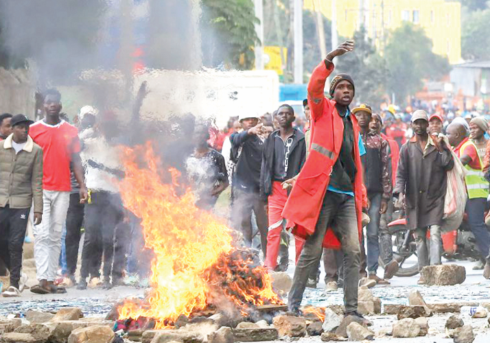 Demonstrators light fires and block roads as they protest tax increases in Nairobi.