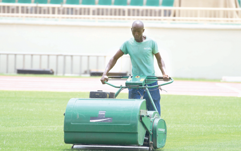 A grounds worker trims grass at the Nyayo Stadium before a previous international match. PHOTO/David Ndolo