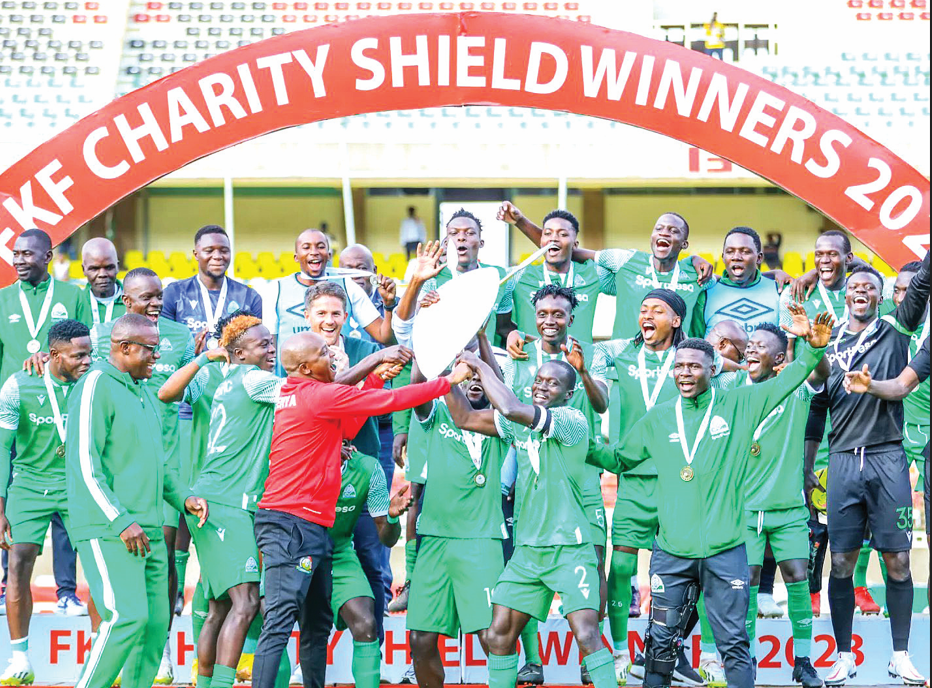 FKF president Nick Mwendwa (centre) presents Gor Mahia players with the Charity Shied after they beat Kakamega Homeboyz to win it as a curtain raiser for the new season. PHOTO/ Sportpicha