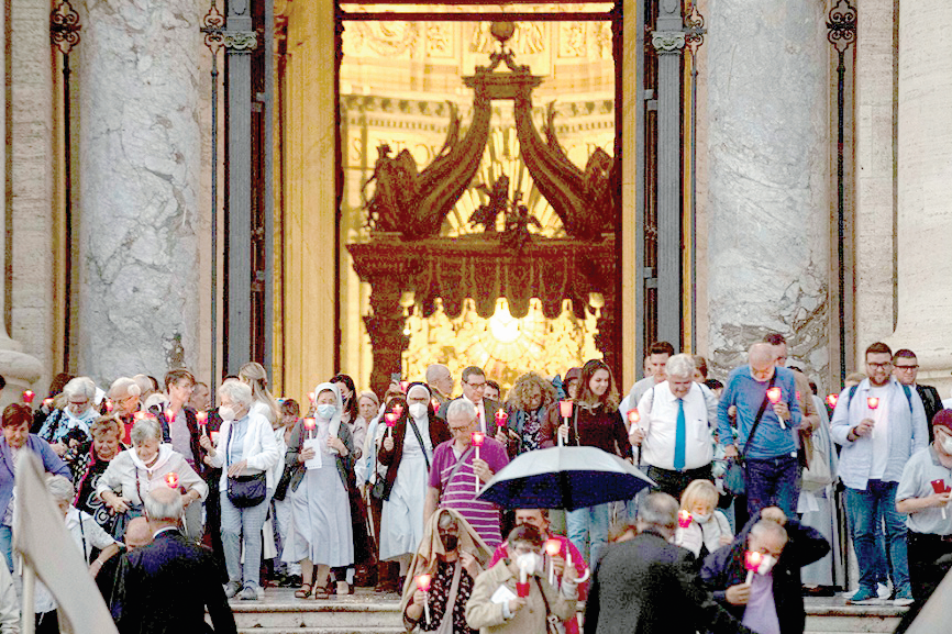 People holding lighted candles leave St Peter’s Basilica after Pope Francis celebrated Mass October 11 to mark the 60th anniversary of the opening of the Second Vatican Council. PHOTO/Vatican Media