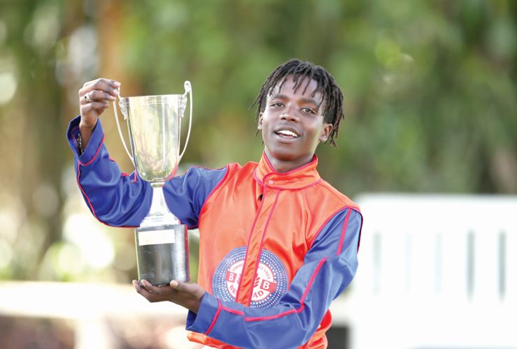 Jockey Michael displays his trophy after clinching victory during the 1000m Alpha Romeo Trophy Feature Race at the Ngong Racecourse on Sunday, October 15, 