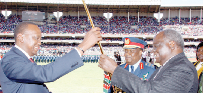 Fourth President Uhuru Kenyatta receives instruments of power from his predecessor Mwai Kibaki in the presence of then Chief Justice Willy Mutunga on April 9, 2013. PHOTO/Print