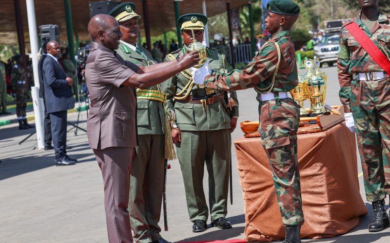 President Ruto awards a trophy to a ranger during Forest Rangers' pass out parade