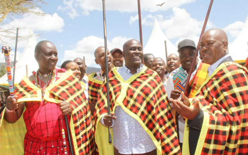 Moses Ole Sakuda(L) and  statehouse comptroller (r) at Sakuda's Kimuka home engage in a song gig . PHOTO/Christine Musa