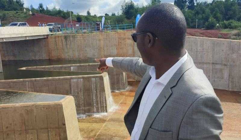 Athi Water Works Development Agency engineer Mukabi points at the spillway. PHOTO/Mathew Ndung'u