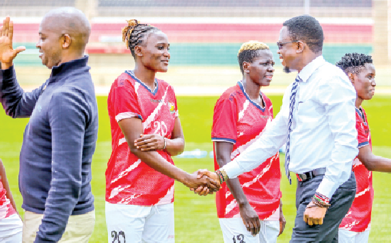 Sports Minister Ababu Namwamba (right) greets Harambee Starlets players after their final training session at Nyayo Stadium before facing Botswana. PHOTO/David Ndolo