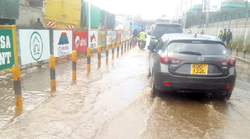 Motorists drive through a flooded section of Mombasa Road, Nairobi, yesterday.PHOTO/David Ndolo