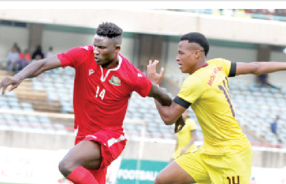 Kenya’s forward Michael Olunga (left) beats Francisco Muchanga of  Mozambique during their friendly match at Kasarani on October 13, 2019. PHOTO/Phillip Kamakya