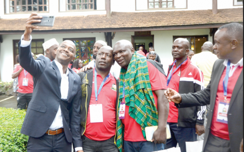 FKF president Nick Mwendwa (left) takes a selfie with federation delegates during a past AGM in Nairobi.
