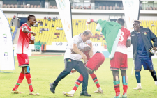 Harambee Stars players pour water to head coach Engin Firat (centre) as they celebrate winning the Four Nations tournament in Malawi two weeks ago.
