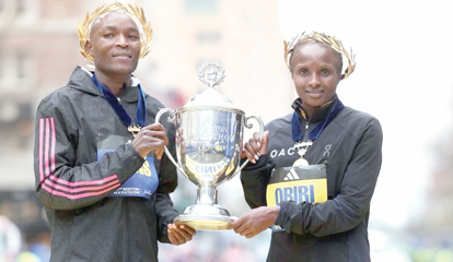 Hellen Obiri (right) and Evans Chebet after they both won the 2023 Boston Marathon races. Yesterday Obiri successfully defended the women title while Chebet finished third. PHOTO/Print