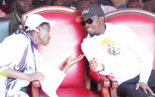 Sports CS Ababu Namwamba consults with Principal Secretary SME's Susan Auma Mangeni when they attended the annual Bunyala cultural event in December 2022. PHOTO/Print