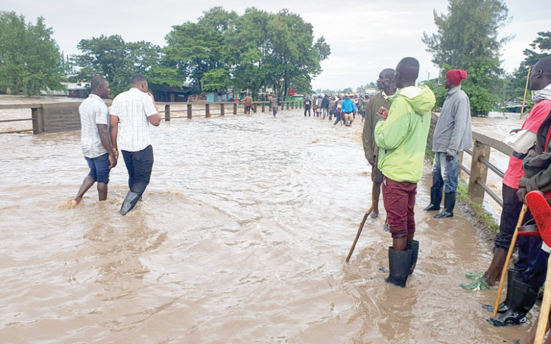 Traffic police officers man both ends of the Ahero bridge as residents travel into and out of Kisumu. PHOTO/Kepher Otieno