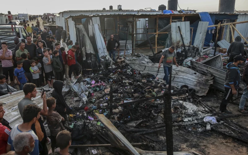 Palestinians look at the destruction after an Israeli strike in Rafah, Gaza Strip. PHOTO/AP