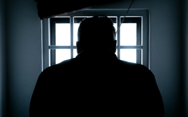 A man standing by the window. PHOTO/Pexels