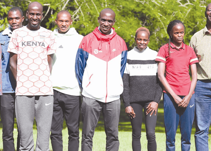 Team Kenya marathoners Eliud Kipchoge, Benson Kipruto, Alexander Munyao, Peres Jepchirchir and Brigid Kosgei pose with NOCK officials at a joint press conference yesterday. PHOTO/NOCK