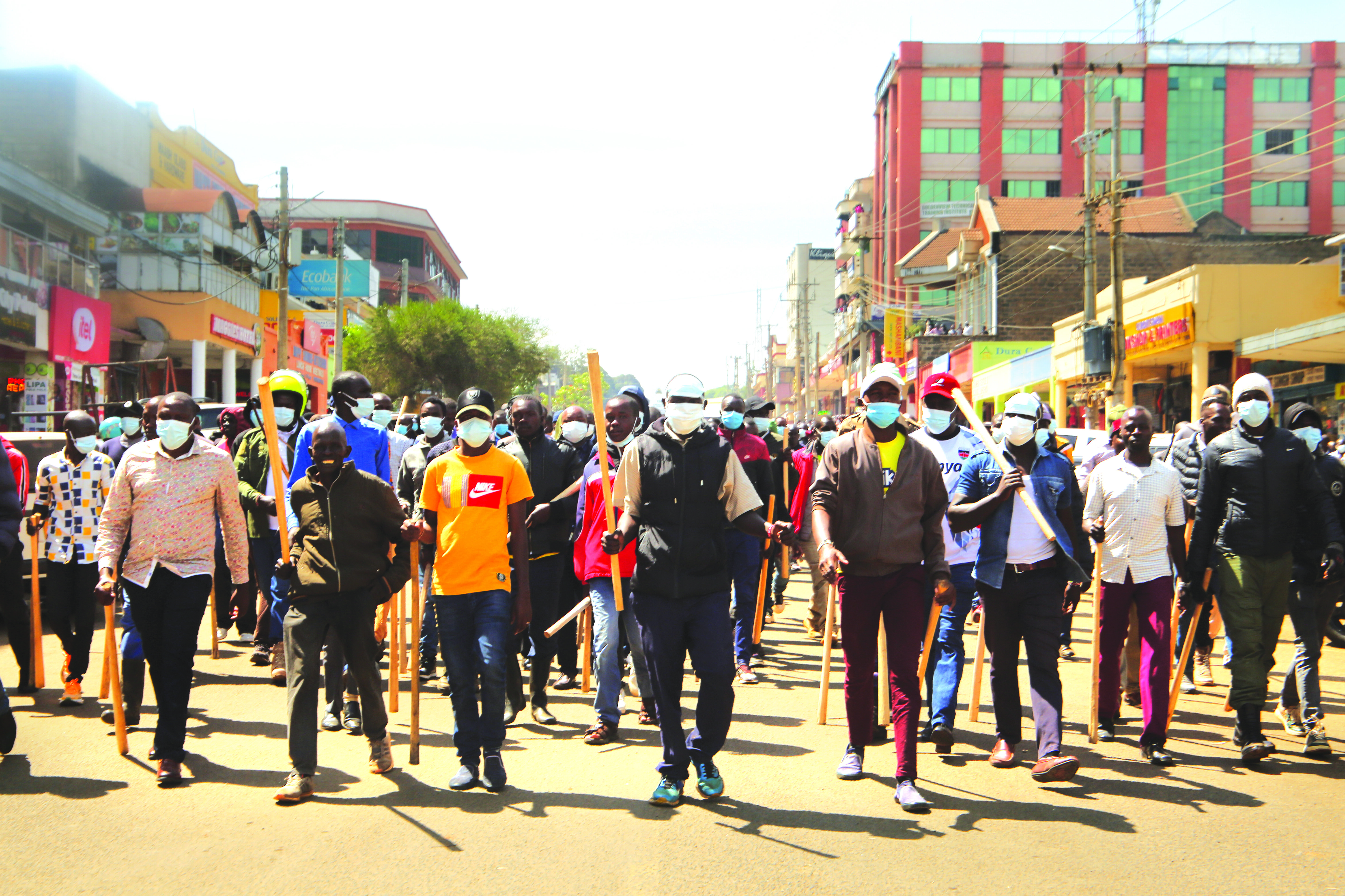 Youths armed with wooden batons, bows and arrows roam Eldoret town. PHOTO/Winstone Chiseremi