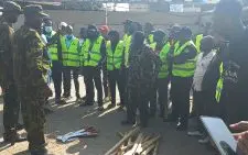 Police in Kitengela disarm youth with crude weapons stationed to guard an entertainment joint at Kitengela Quiver lounge. PHOTO /Christine Musa