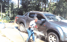 Margaret Gitonga attends to a customer’s vehicle at a carwash. PHOTO/PRINT.