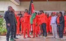 CS Kipchumba Murkomen handing over the Kenyan flag to Under-20 athletics team. PHOTO/@kipmurkomen/X