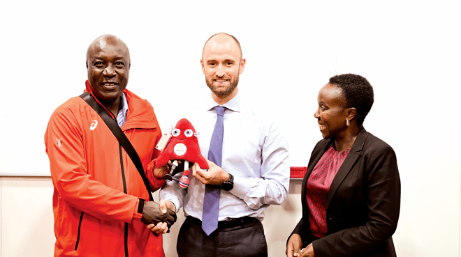 France Ambassador of Sports Samuel Ducroquet gifts Kenya’s head of delegation at the Paris Paralympics, Sports Administrative Secretary Evans Achoki (left) as Kenya’s ambassador to France, Betty Cherwon looks. PHOTO/James Waindi