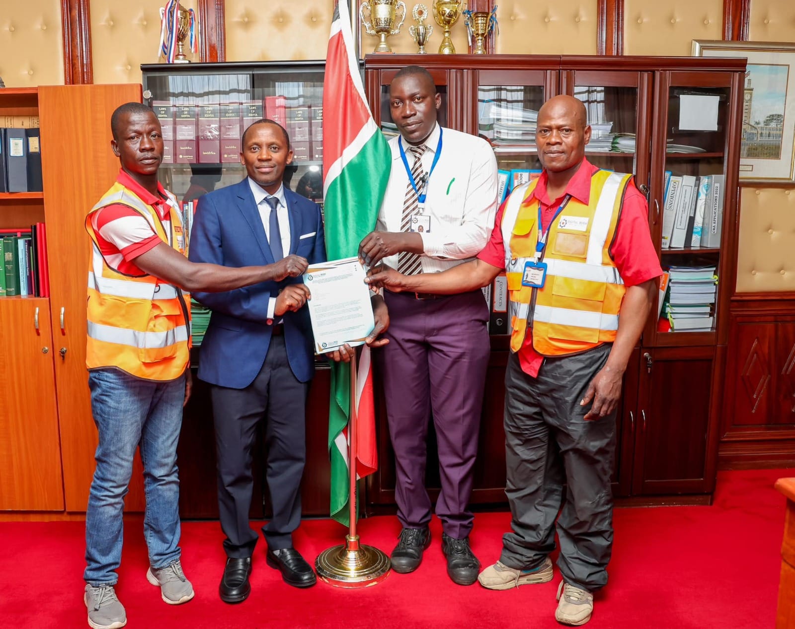 The Clerk of the National Assembly Samuel Njoroge receiving digital boda boda riders' petition. PHOTO/https://www.facebook.com/ParliamentKE