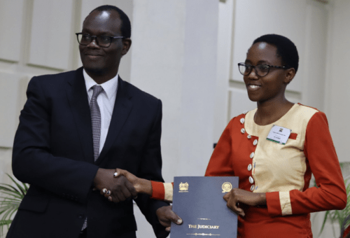 Deputy Chief Registrar of the Judiciary Paul Ndemo poses for a photo with a newly sworn in member. PHOTO/@Kenyajudiciary/X
