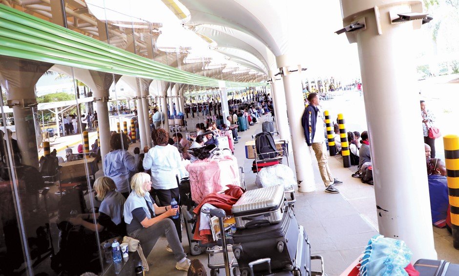 Some of the stranded passengers at Jomo Kenyatta international Airport in Nairobi yesterday . PHOTO/BERNARD MALONZA