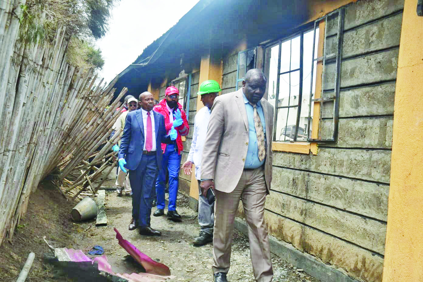 Interior CS Kithure Kindiki with DCI officers and Red Cross officials on Friday at the scene of a fire at Hillside Endarasha Academy that killed 21 children in a dormitory on Thursday night. PHOTO/Joseph Kong'ori