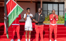 President William Ruto hands Kenyan flag to Junior Starlet players on Wednesday September 18, 2024. PHOTO/@WilliamsRuto/X