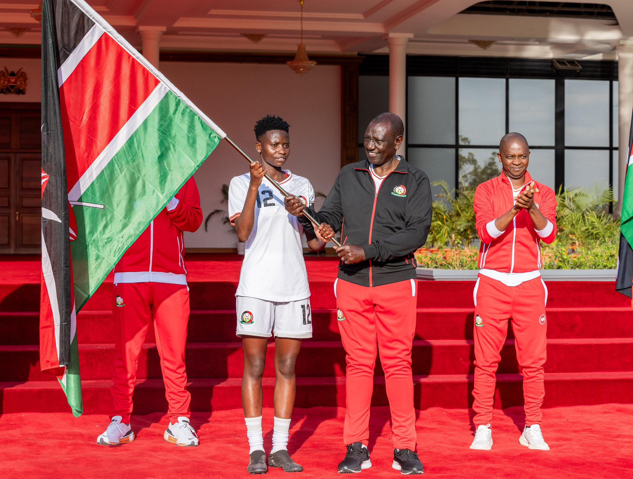 President William Ruto hands Kenyan flag to Junior Starlet players on Wednesday September 18, 2024. PHOTO/@WilliamsRuto/X