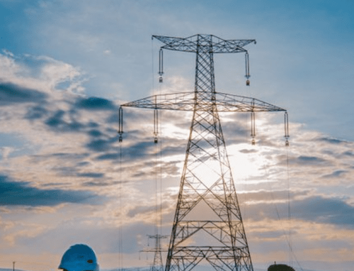 A KETRACO employee walks below a power line. PHOTO/@KETRACO1/X