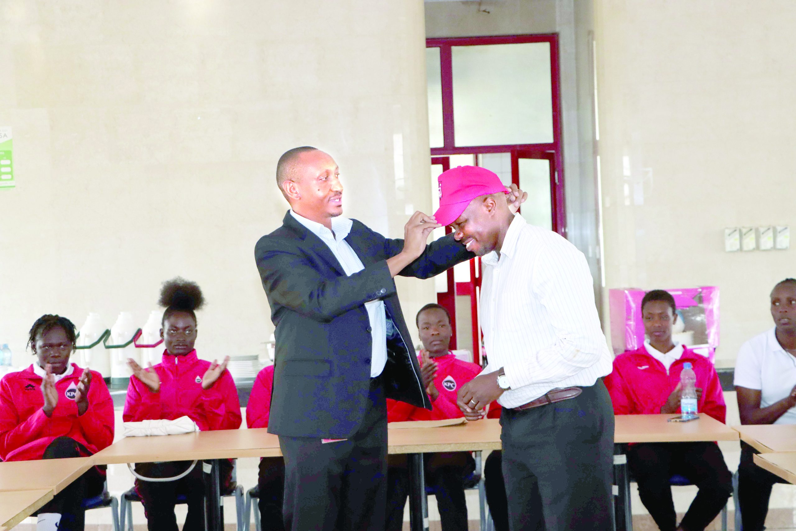 KPC volleyball club chairperson Paul Njuguna (L) welcomes the new head coach Geoffrey Omondi (R) during a welcoming ceremony held at KPC headquarters. PHOTO/Print