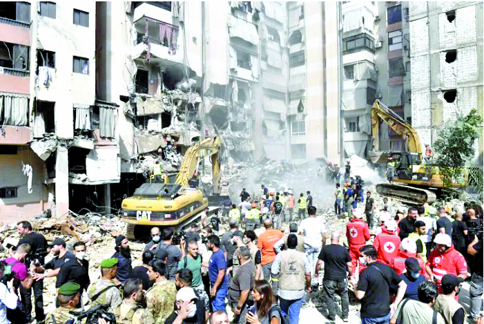 Officers use heavy construction equipment to remove debris from heavily damaged settlements following the Israeli army’s air strike on September 21. PHOTO/Print