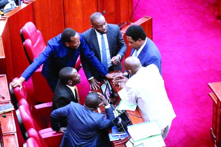 Members of the Senate huddle in consutlations during Deputy President Rigathi Gachgua’s impeachment trial yesterday. PHOTO/KENNA CLAUDE