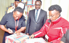 Education CS Julius Ogamba (centre) when he oversaw the distribution of KCSE papers at the Lang’ata Deputy County Commissioner’s Office yesterday. PHOTO/Philip Kamakya