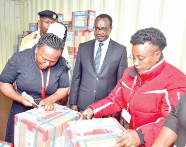 Education CS Julius Ogamba (centre) when he oversaw the distribution of KCSE papers at the Lang’ata Deputy County Commissioner’s Office yesterday. PHOTO/Philip Kamakya