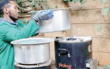 A worker performs a demonstration of clean cookstoves in Ruiru, Kiambu.